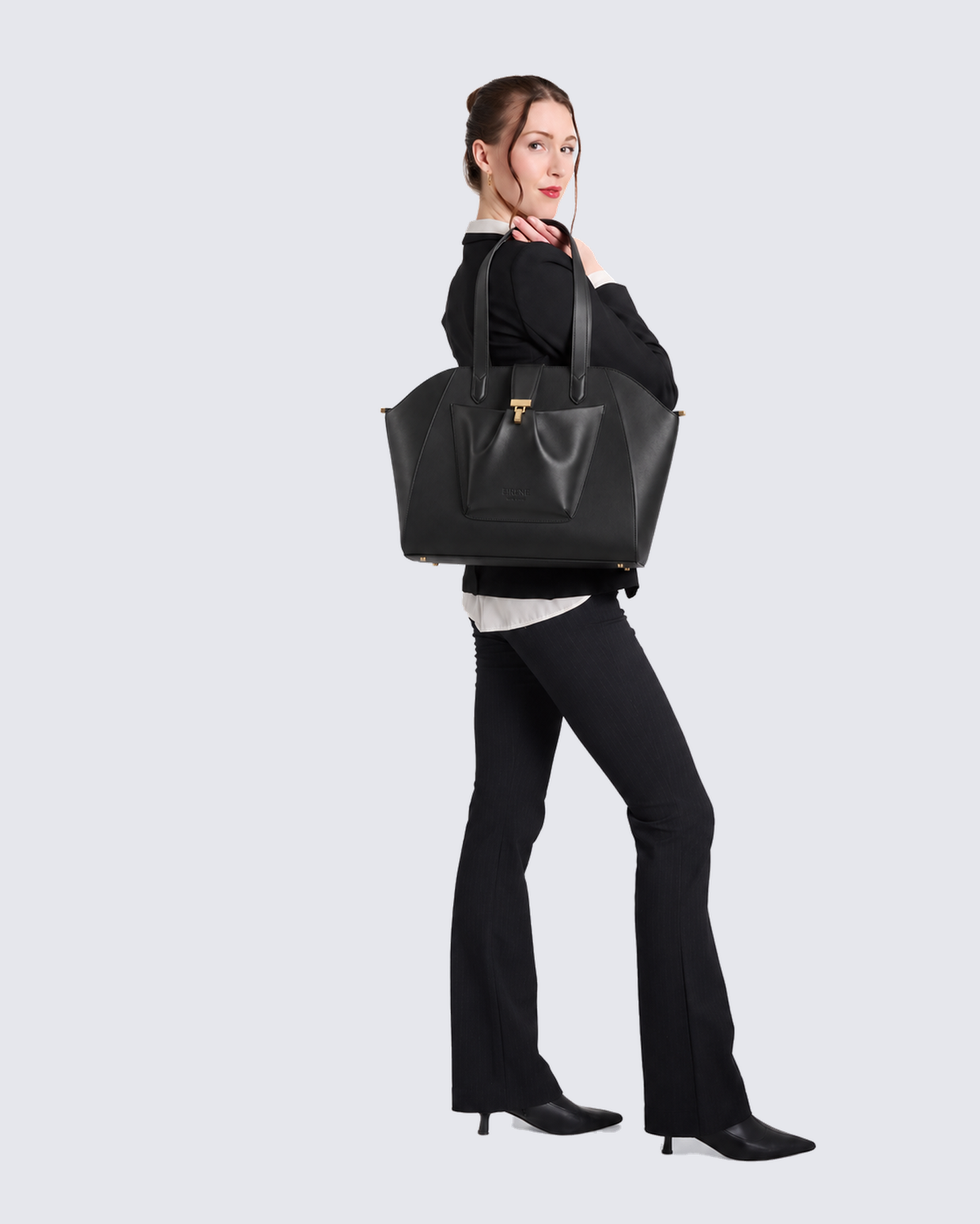 The Fiora Tote Travel Edition in Jet Black, on the shoulder