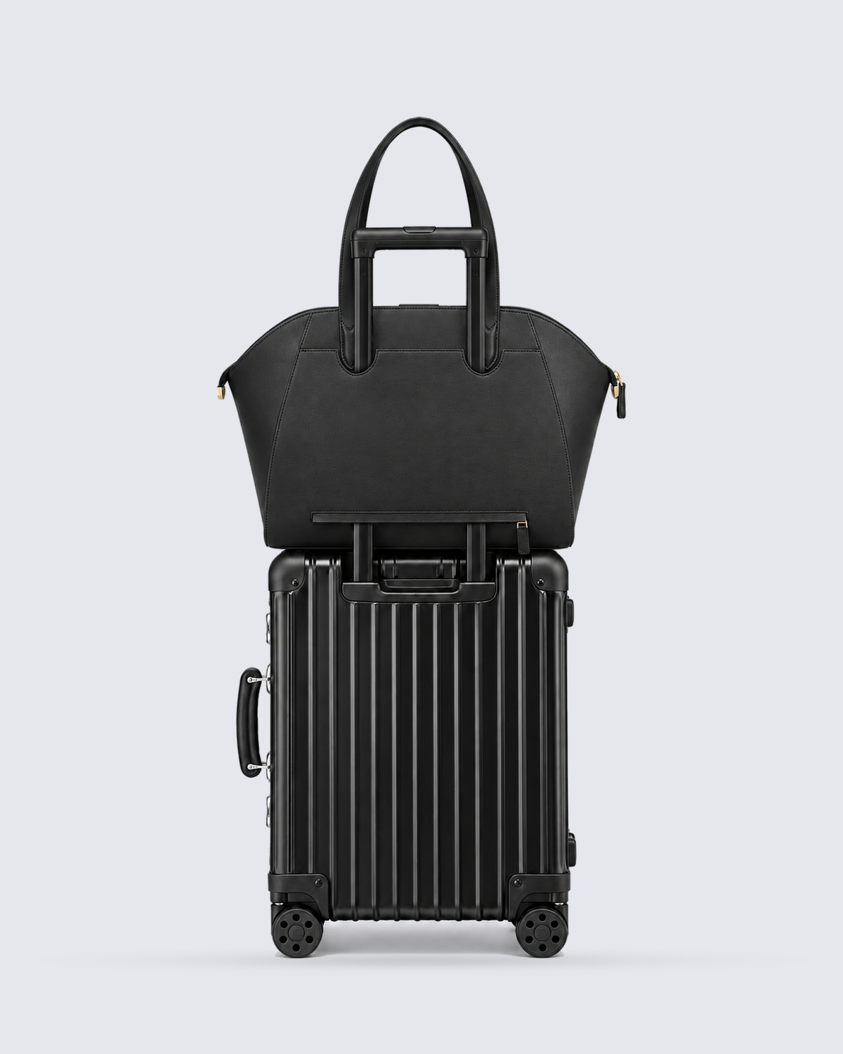 The Fiora Tote Travel Edition in Jet Black, on a trolley, back