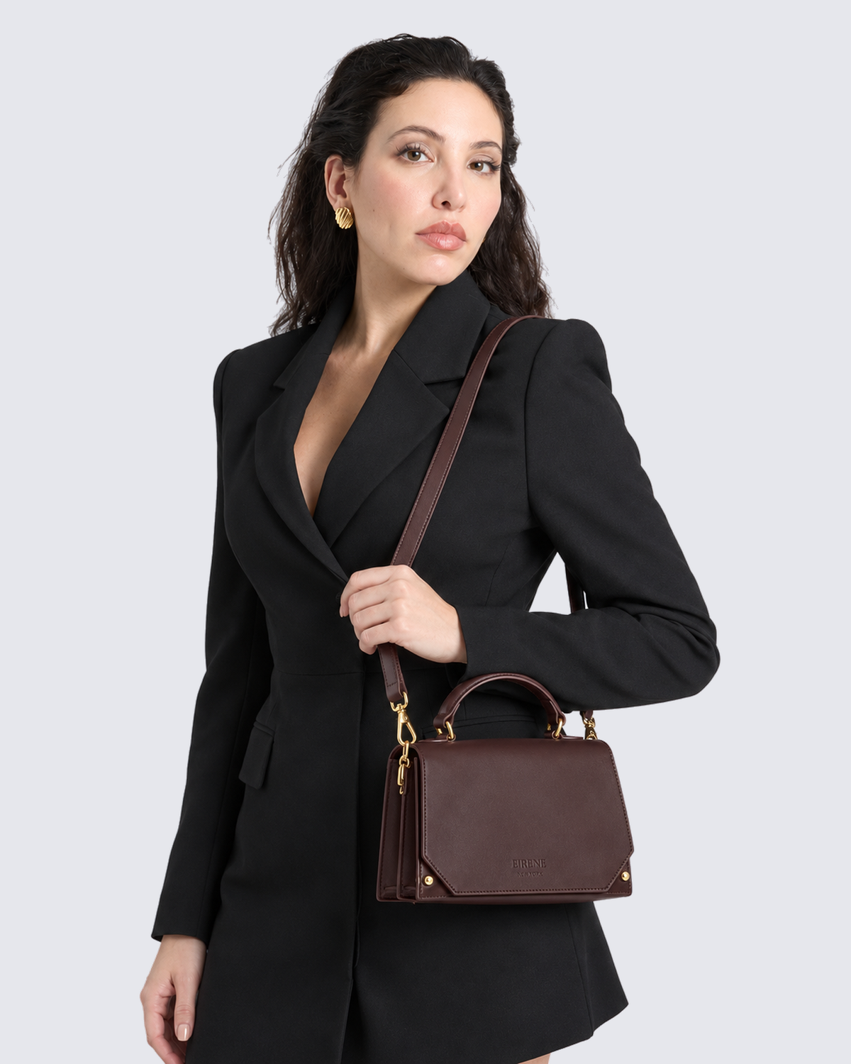 The Siena Mini Purse in Dark Brown, on the shoulder
