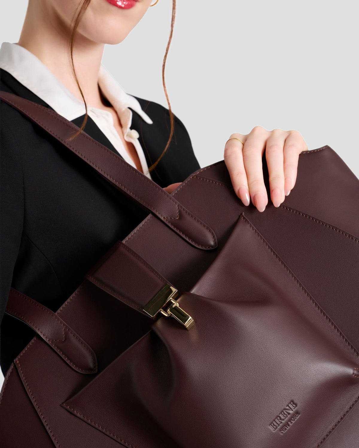 Model walking with the Fiora Tote in Jet Black