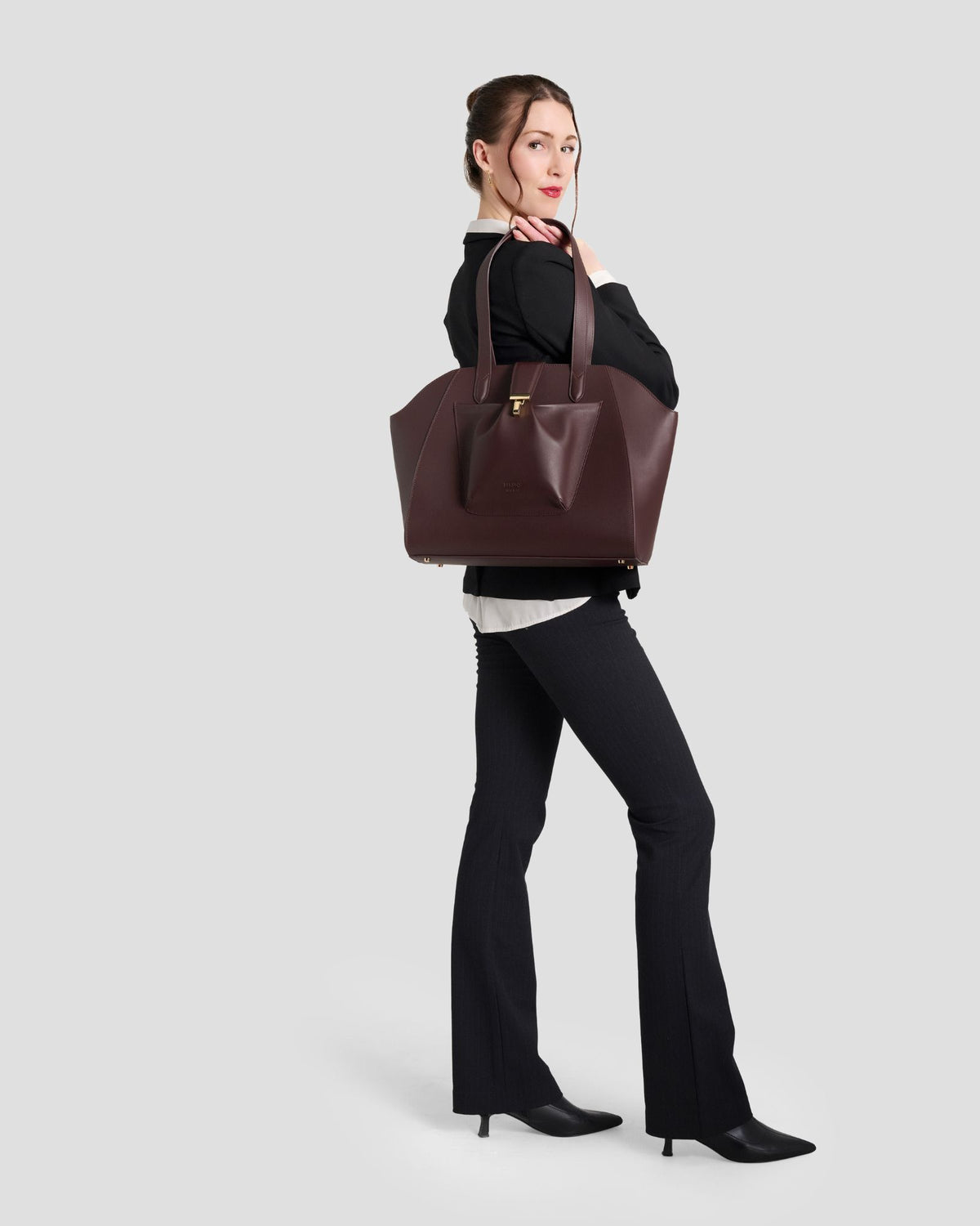 Model walking with the Fiora Tote in Jet Black