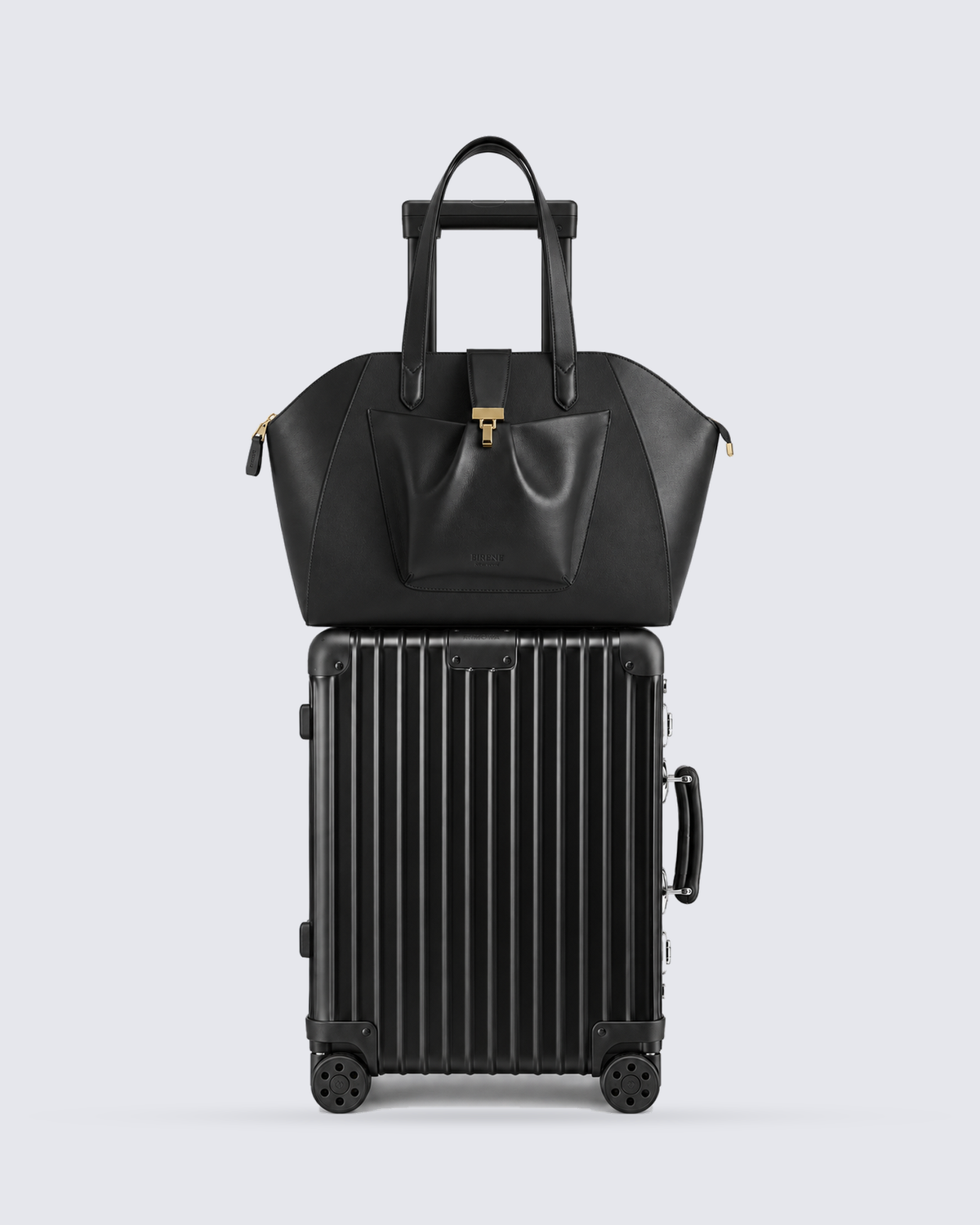 The Fiora Tote Travel Edition in Jet Black, on a trolley, front