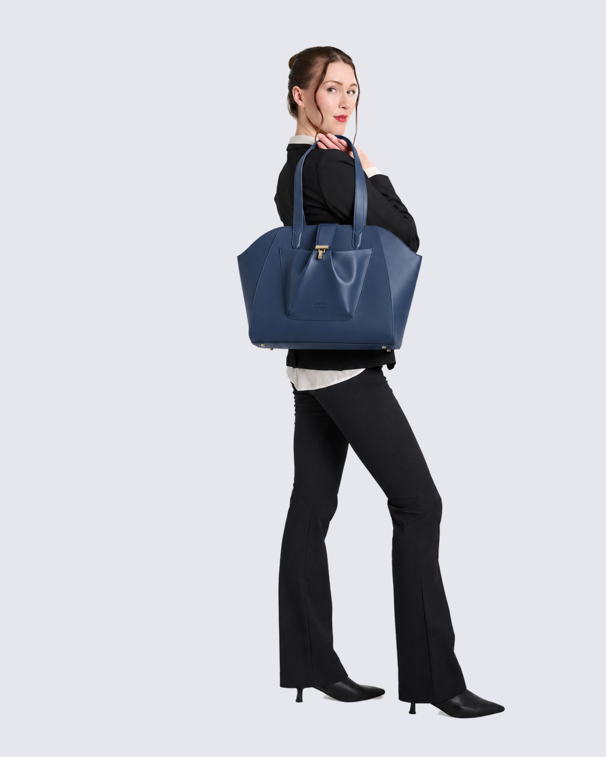 The Fiora Tote Travel Edition in Navy Blue, on the shoulder