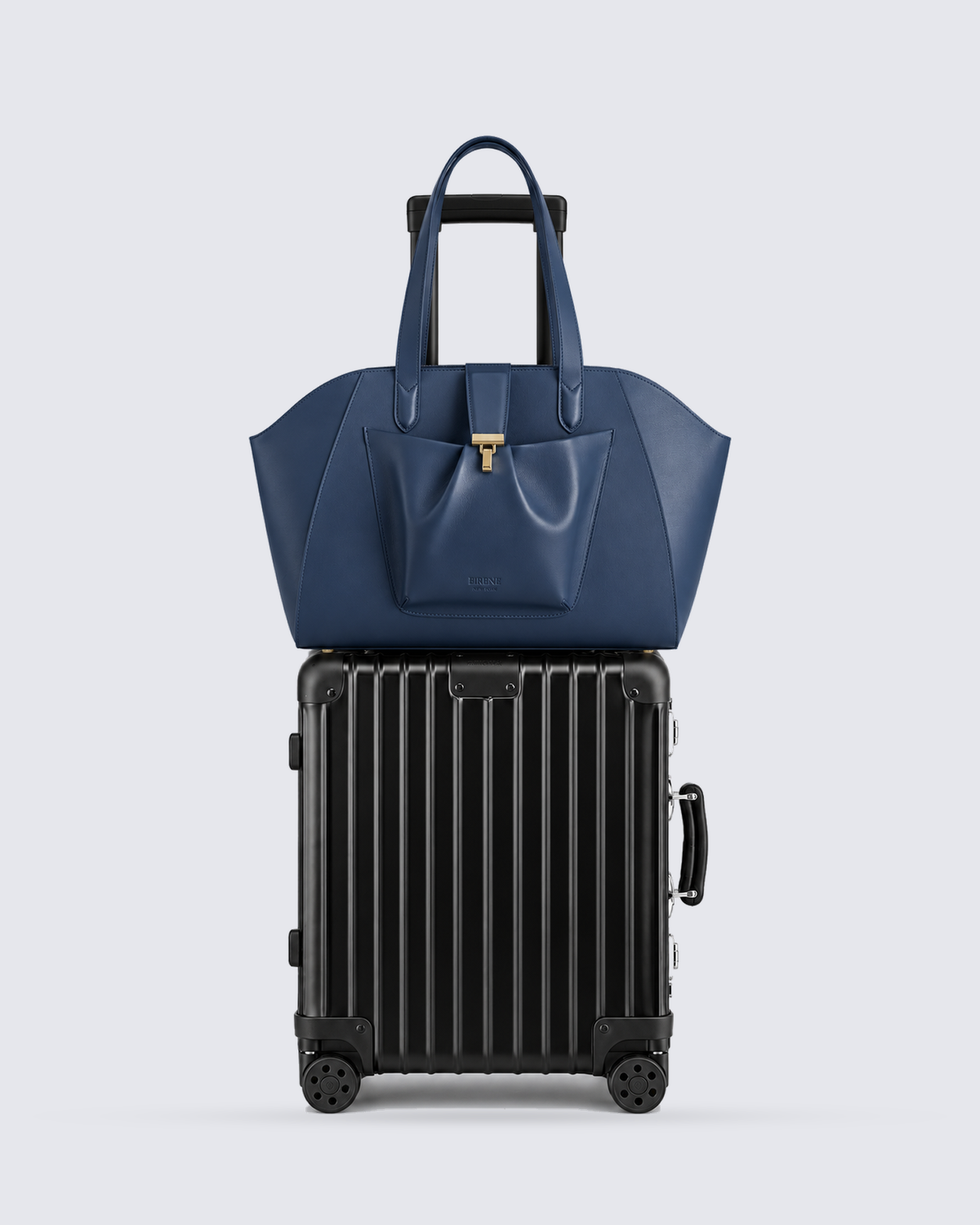 The Fiora Tote Travel Edition in Navy Blue, on a trolley, front