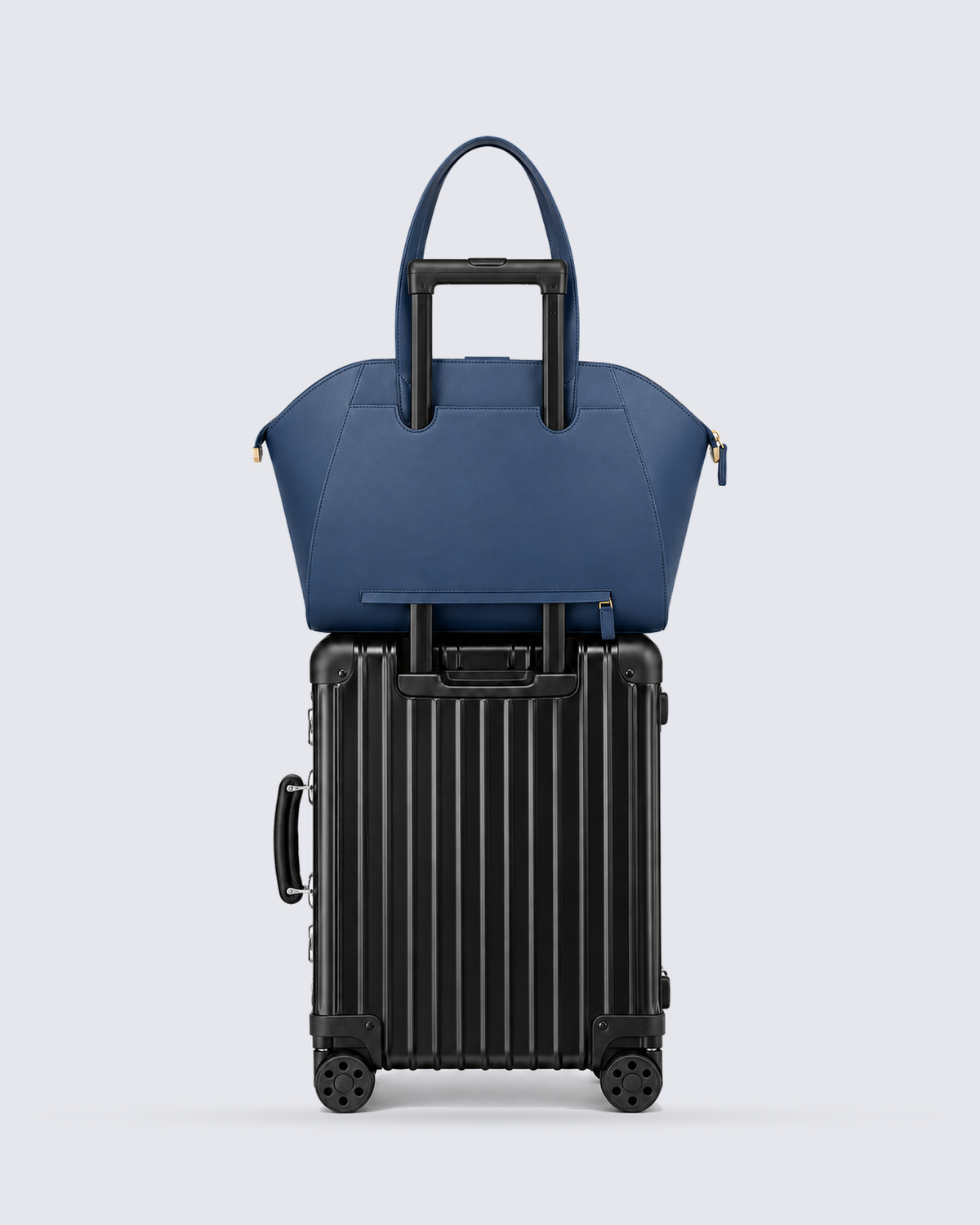 The Fiora Tote Travel Edition in Navy Blue, on a trolley, back