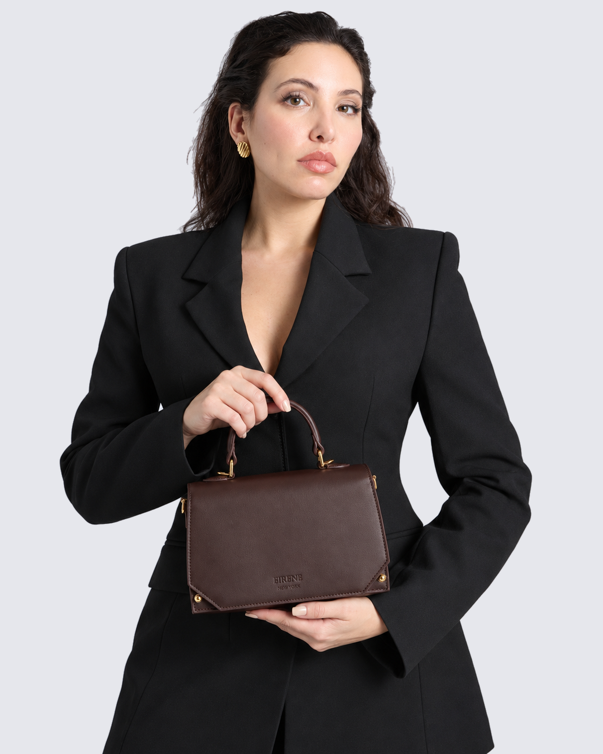 The Siena Mini Purse in Dark Brown, in hand